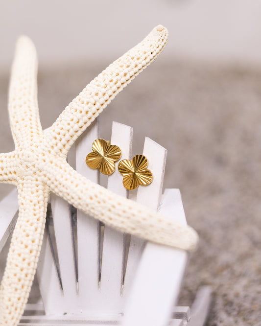 Textured gold earrings shaped like clovers, lightweight and water-resistant for everyday elegance
