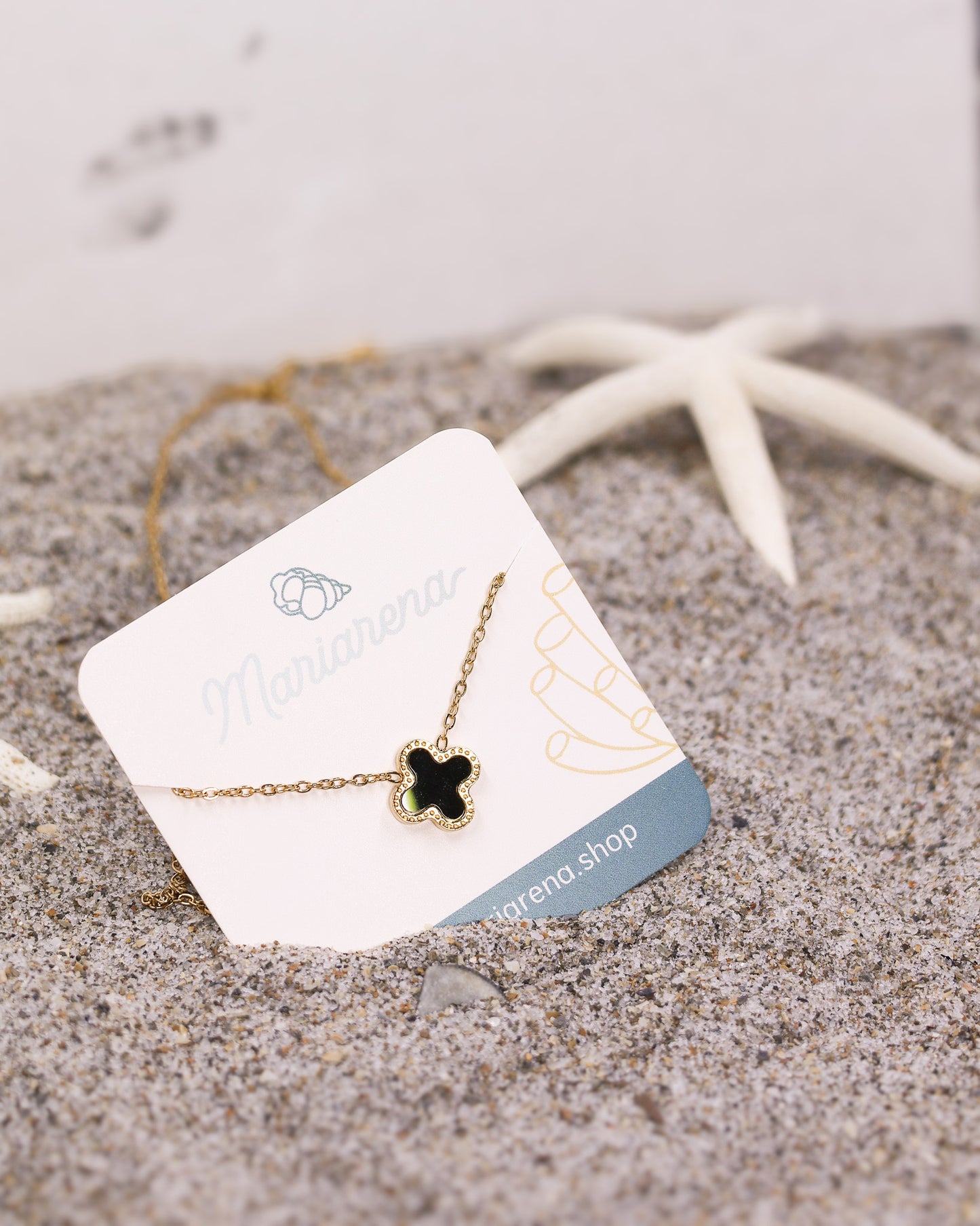 Elegant gold necklace with minimalist black enamel lucky clover pendant