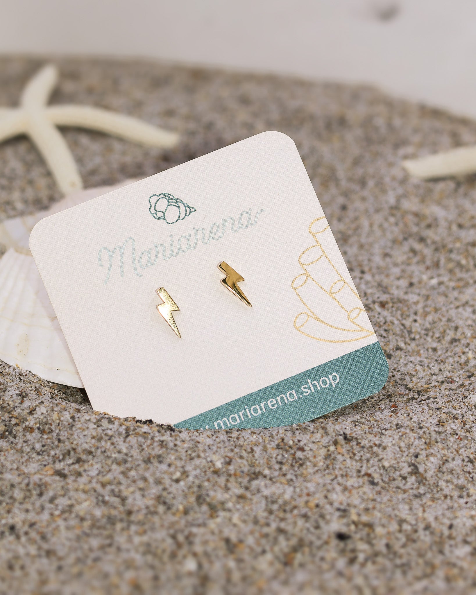 Close-up of golden lightning earrings with hypoallergenic finish