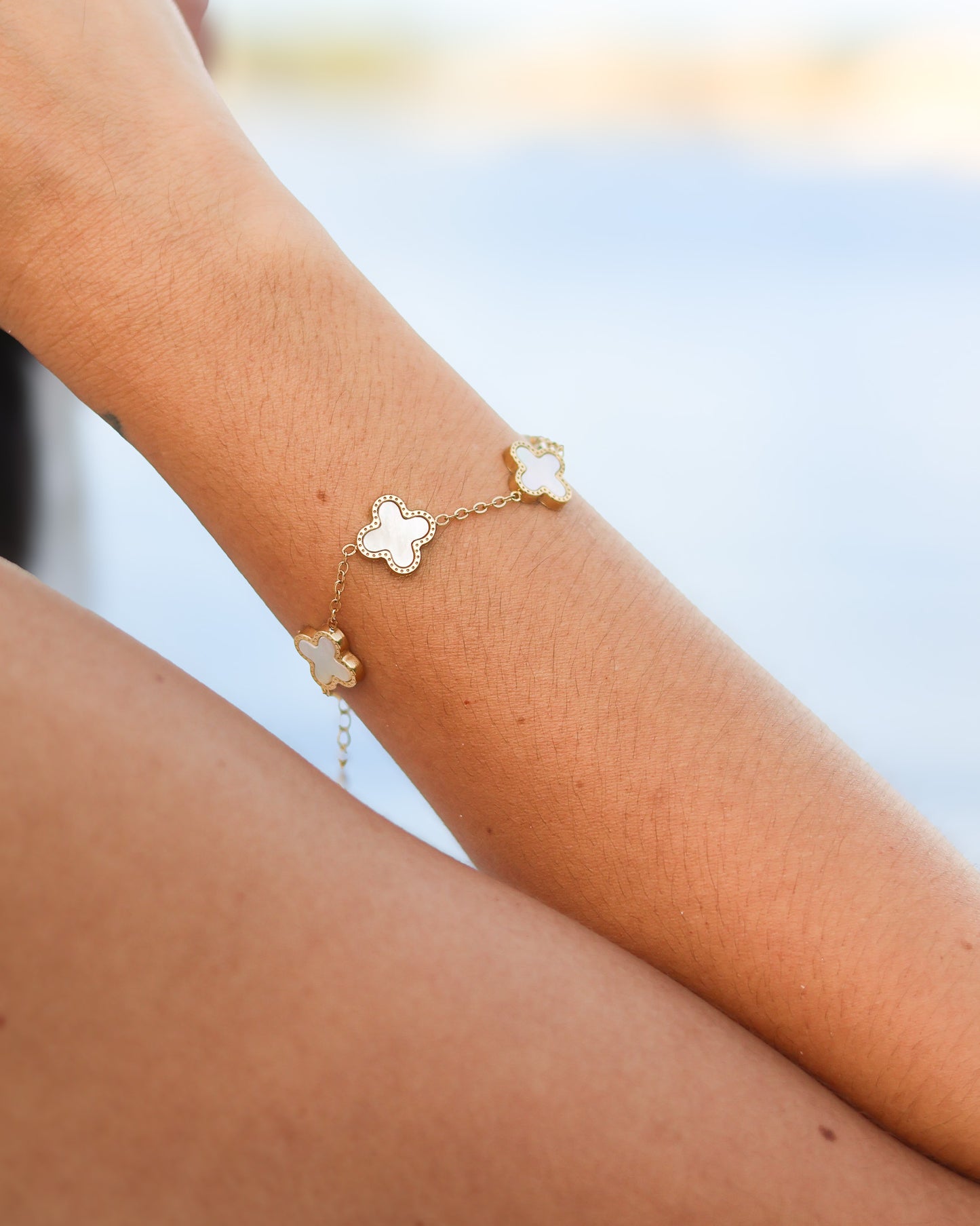 White and gold enamel charm bracelet styled for everyday coastal wear
