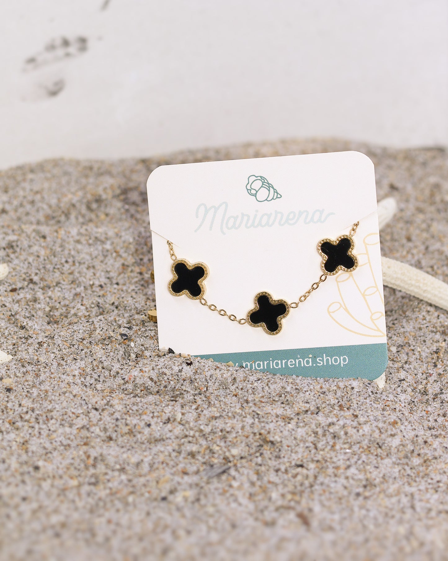 Glossy black and gold clover charm bracelet designed for daily elegance
