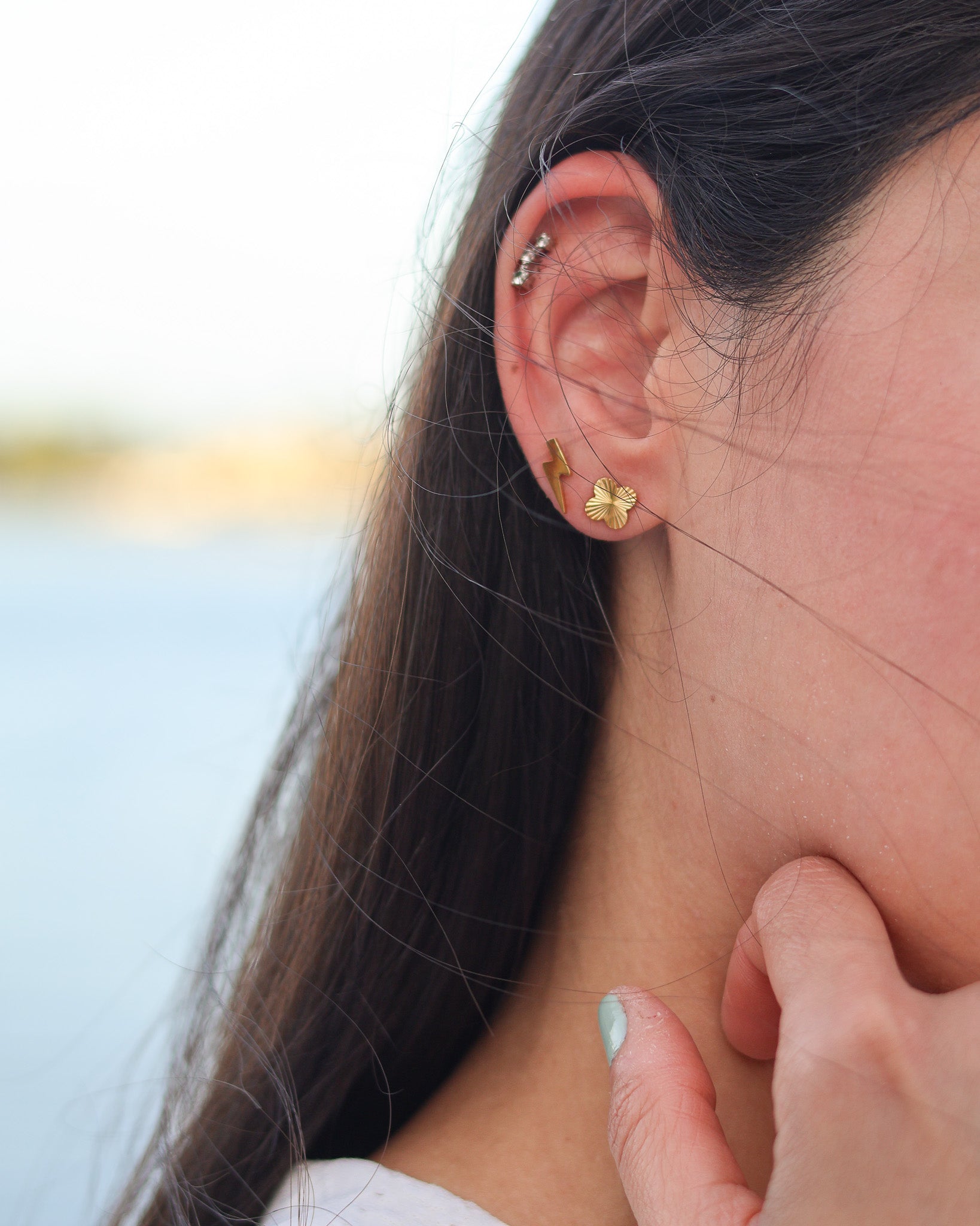 Minimalist clover earrings with polished texture, designed to add luck and shine to your daily outfits